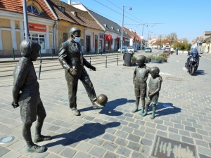 A group of statues in Buda of Ferenc Puskás legendary Hungarian football player and some kids watching him play