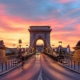 Sunset photo of the first permanent bridge connecting Pest and Buda, the iconic Chain bridge