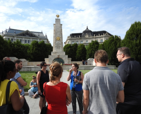 A group with our guide in blue uniform on the Liberty square, in front of the Soviet war memorial of Budapest